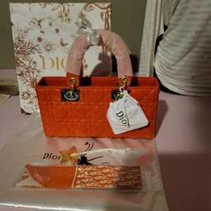 Orange quilted handbag with crossbody strap